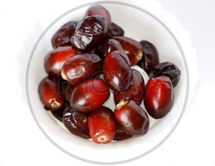 Dark Red Dates Fruit Or Date Palm In White Background. Selective Focus