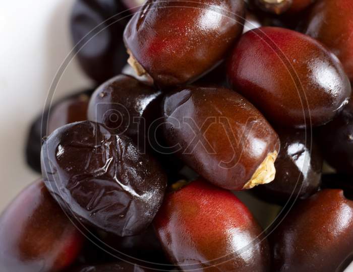 Dark Red Dates Fruit Or Date Palm In White Background. Selective Focus