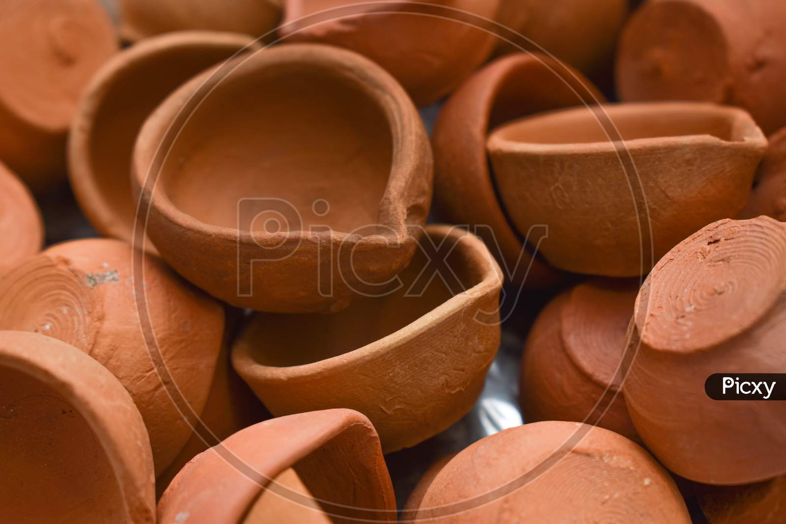 Heap Of Indian Clay Diyas Or Oil Lamp For Diwali Festival .Closeup Shot For Background