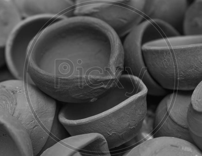 Heap Of Handmade Indian Clay Diyas Or Oil Lamp For Diwali Festival .Black And White Image .