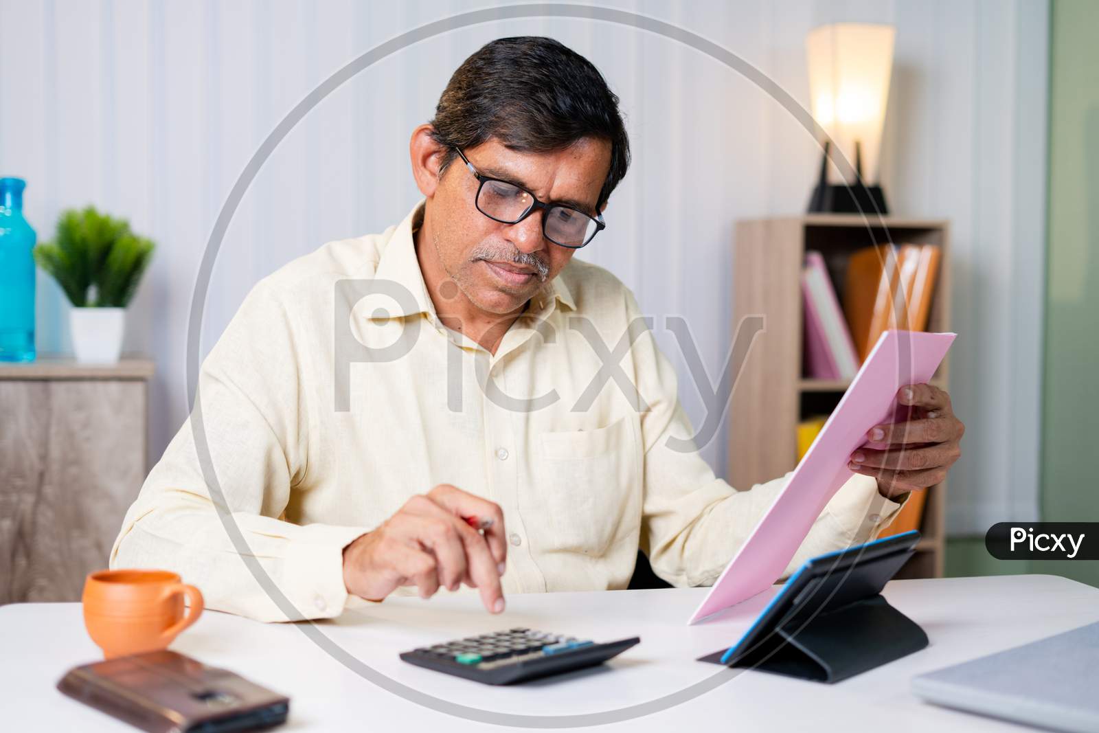 Businessman Checking Or Verifying Bills, Expenses Or Taxes And Calculating Be Seeing Bills And Calculator At Office - Concept Of Managing Budget And Financial Work.