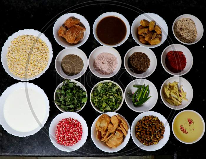 The complete ingredients (curd, lentils, olive oil, black pepper, red chilli powder, green chilli,  black salt and others) for making Dahi Bhalle at home