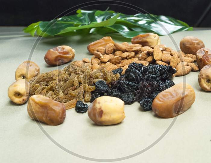 Mix Dry Fruits Nuts Around Dates Isolated Almonds Black And Brown Raisins(Kishmish)