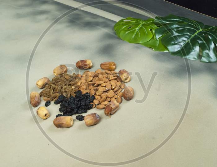 Mix Dry Fruits Nuts Around Dates Isolated Almonds Black And Brown Raisins(Kishmish)