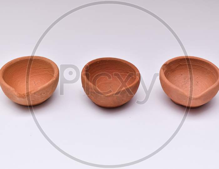 Closeup Photo Of Three Diyas Or Oil Lamp For Diwali Festival Of Lights With White Background