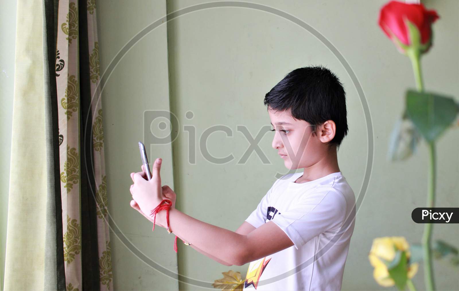Kid Looking At Mobile Screen. Cute Boy Looking At Mobile Screen. Playing on mobile