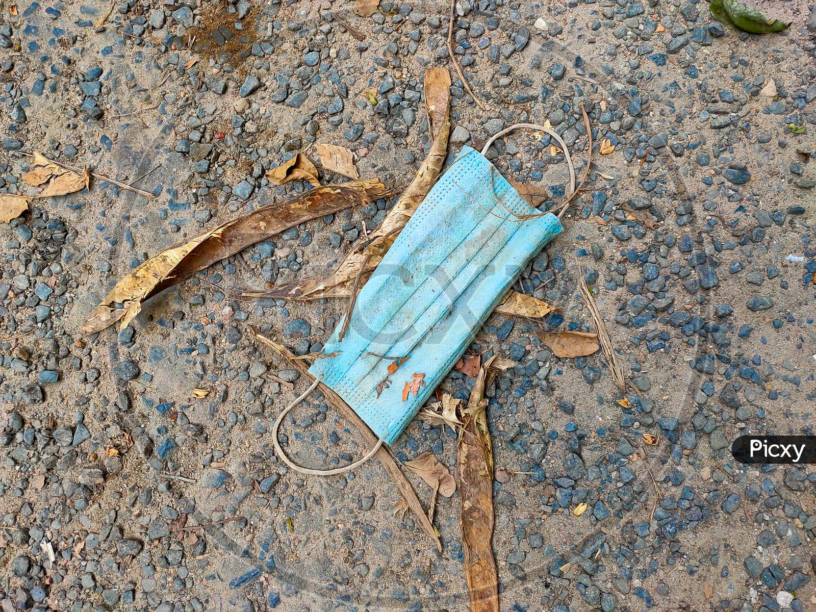 The Environmental Impact Of Abandoned Disposable And Used Face Masks On Street.