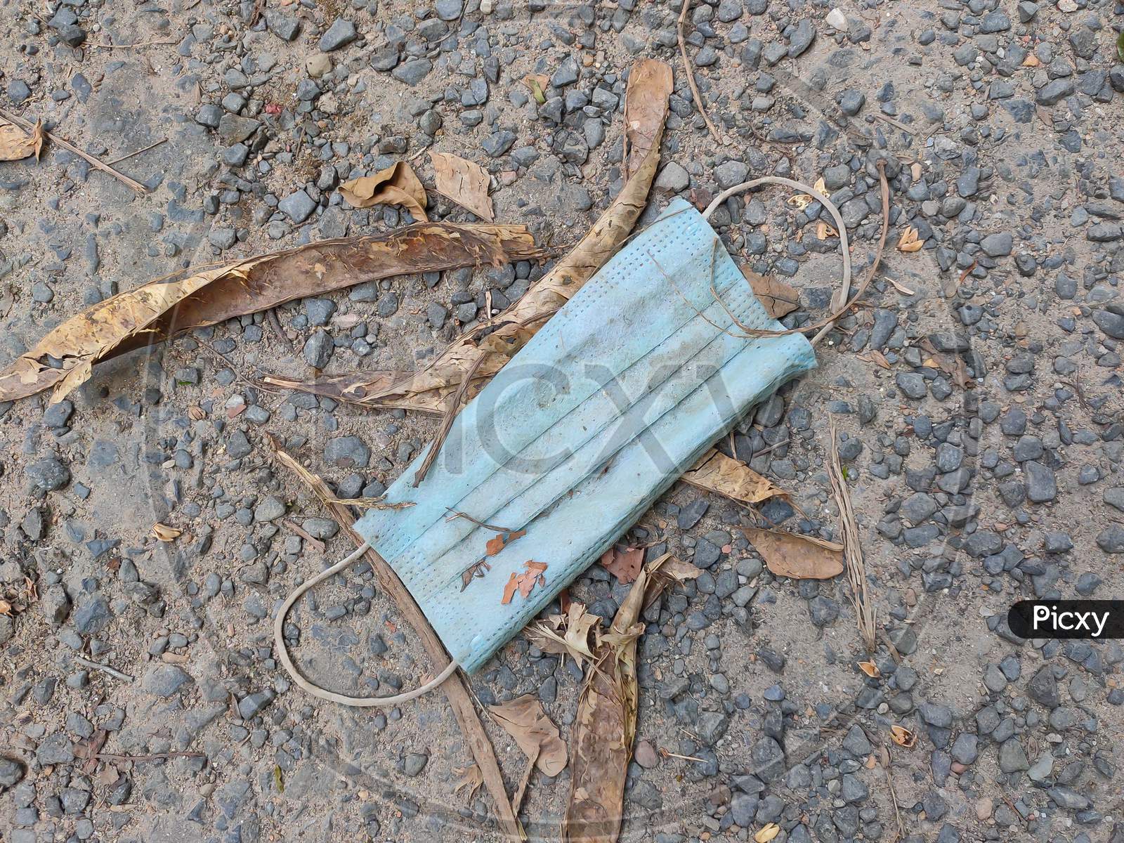 The Environmental Impact Of Abandoned Disposable And Used Face Masks On Street.