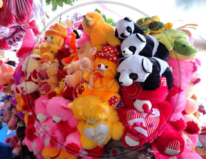 Colourful teddy toys selling on a street shop.