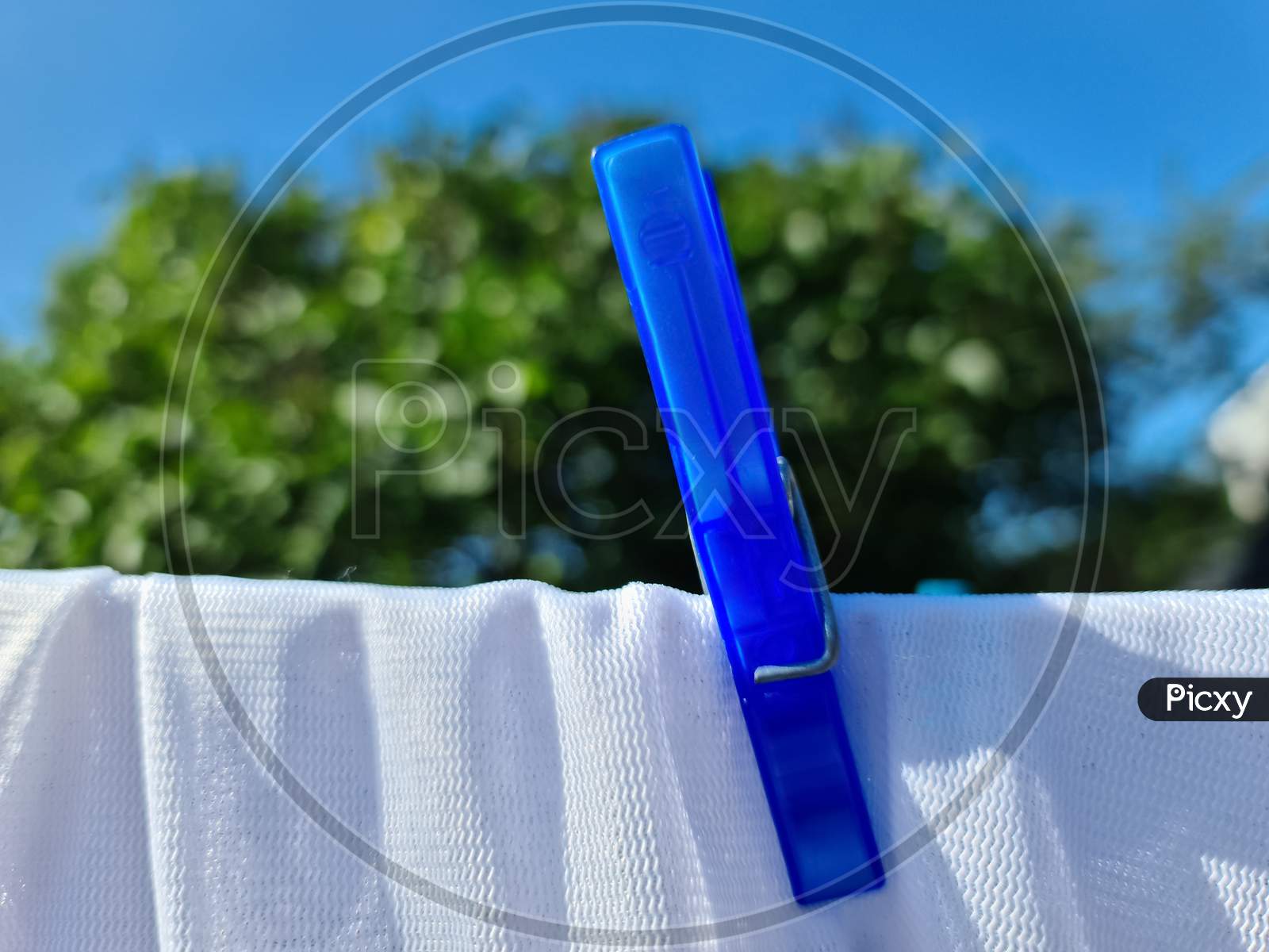 Clothes Hung Out On A Sunny Day To Dry On A Washing Line And Fastened By The Clothes Pegs..