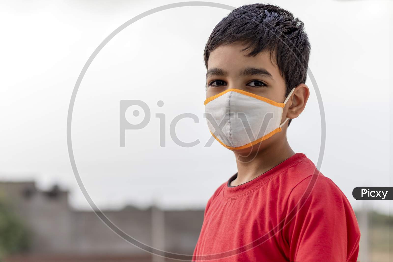 Little Indian cute boy wearing mask during corona virus and flu outbreak. Mask for corona virus prevention.
