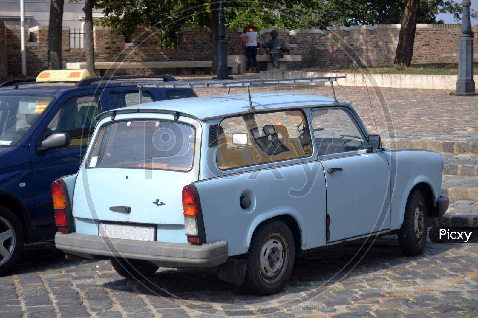 Old light blue car parked on a street in Budapest