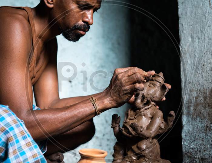 Focus On Hands, Concentrated Artist Making Clay Ganesh Idol For Ganesha Festival - Concpet Of Hindu Religious Festival Preparations In India.