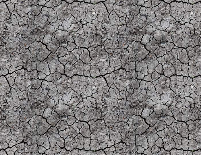 Dried crackd earth soil ground texture background.