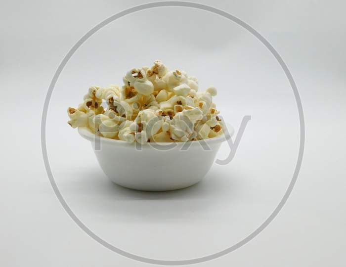 Popcorn In A White Bowl On Isolated White Background