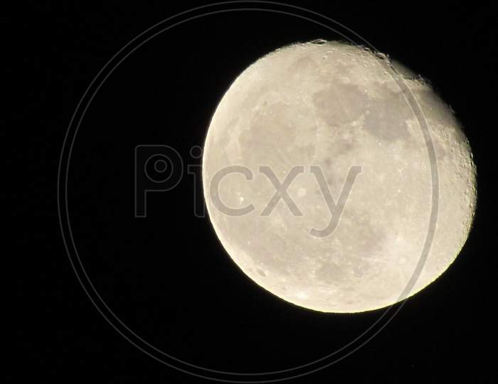 The Moon Close-Up On A Black Night Sky Shot Through A Telephoto Camera.