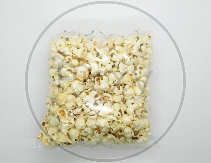Popcorn In A Plastic Bag On Isolated White Background