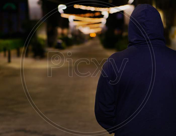 Lonely Man walking on street