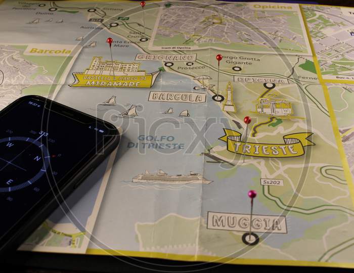 ocation marking with a pin on routes on map. Adventure, discovery, navigation, communication, logistics, geography, transport and travel theme concept background. Mobile compass and Map.