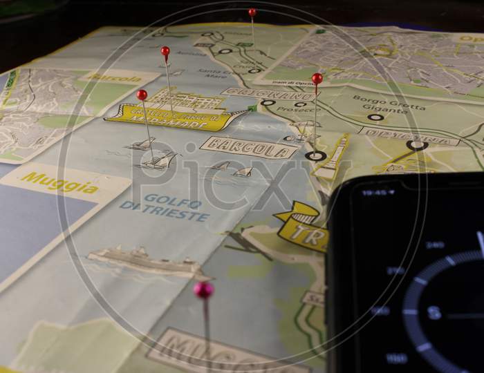 location marking with a pin on routes on map. Adventure, discovery, navigation, communication, logistics, geography, transport and travel theme concept background. Mobile compass and Map