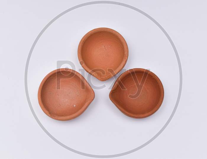 Closeup Shot Of Three Diyas Or Oil Lamp For Diwali Festival With White Background