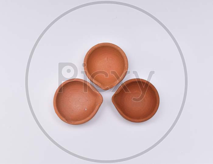 Closeup Shot Of Three Diyas Or Oil Lamp For Diwali With White Background
