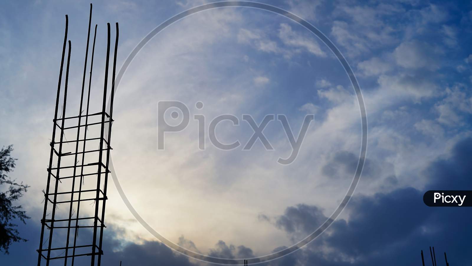 Silhouette Of Construction Elements Set Against A Brooding Cloudy Stormy Sky