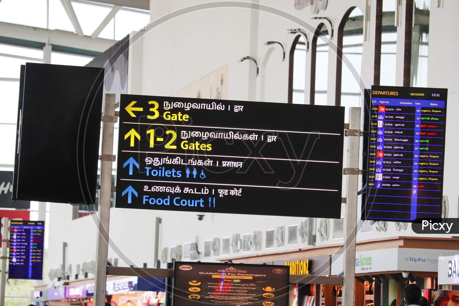 Signboard Displaying Boarding Gate Information In English, Tamil, At The Chennai International Airport.