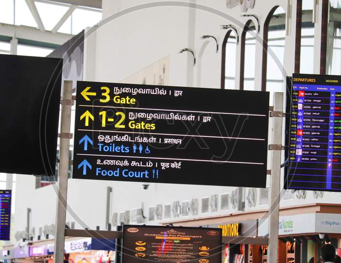 Signboard Displaying Boarding Gate Information In English, Tamil, At The Chennai International Airport.