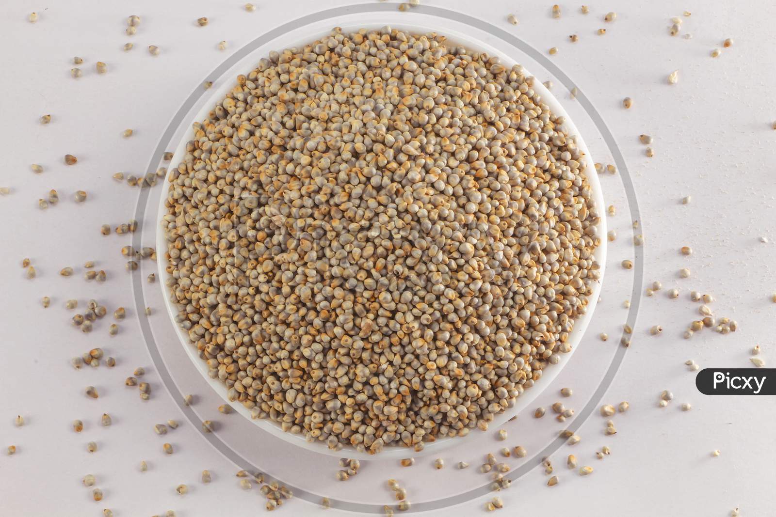 Bowl in white Background containing Pearl Millets