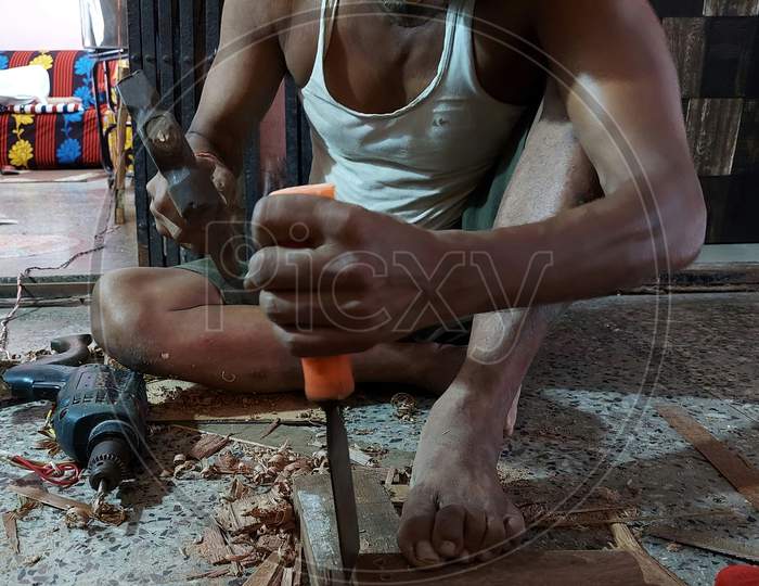 A carpenter  working  with a chisel and hammer with a concept home decoreating  ideas.