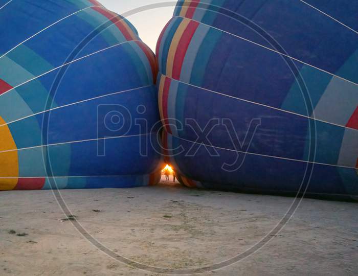 Coloful Air Hot Air Balloons Facing Each Other Being Filled With Helium Gas During Night, Preparation Of A Flight In Goreme National Park In Cappadocia, Turkey