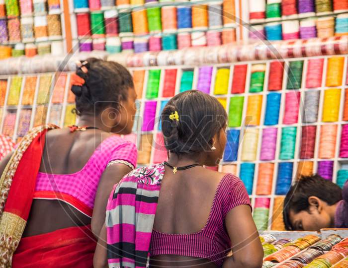 Indian women in traditional cloth shopping colorful Indian bangles