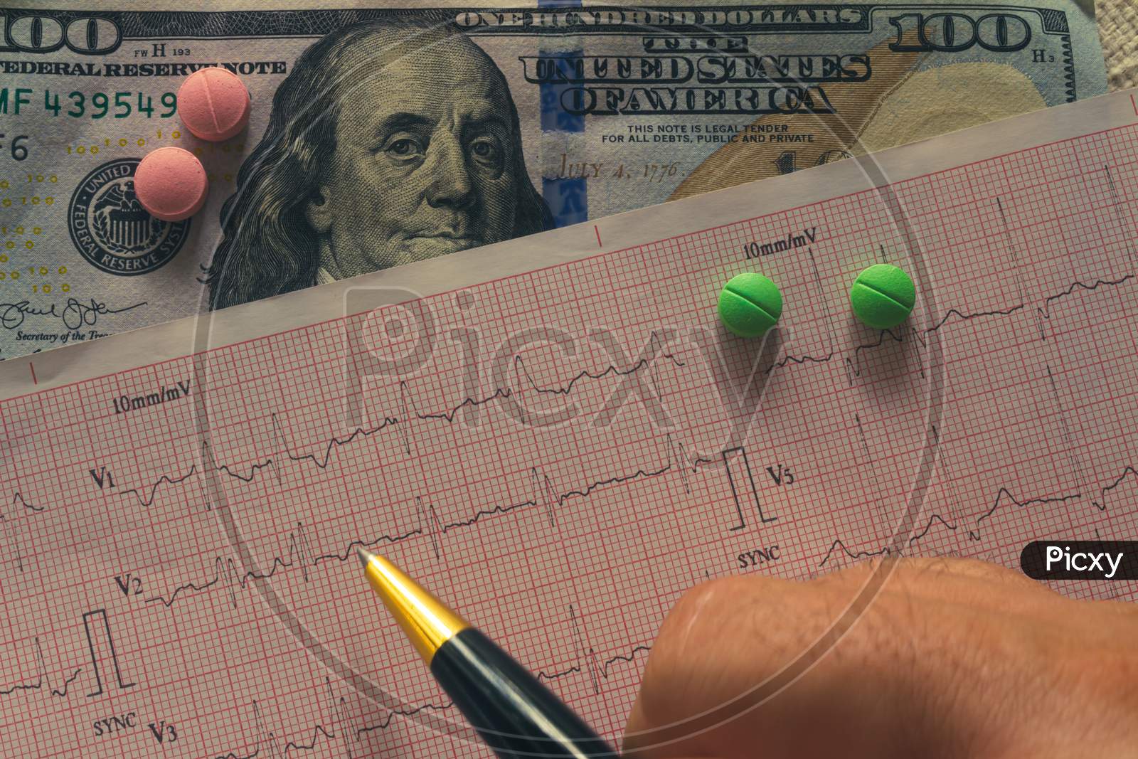 Desk Of A Doctor. Pills Scattered Between Banknotes And Ekg.