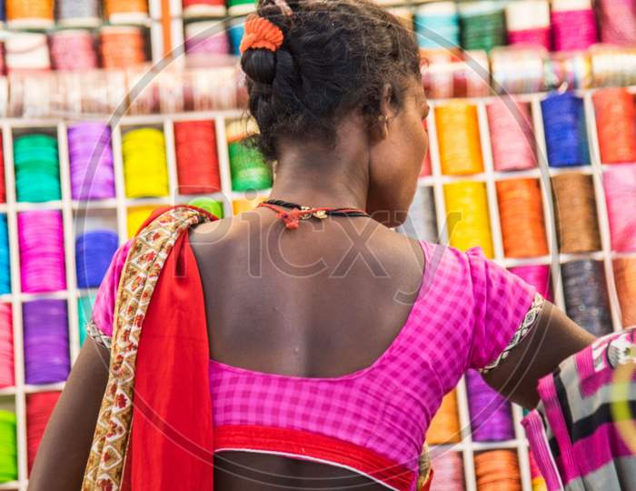 Indian women in traditional cloth shopping colorful Indian bangles