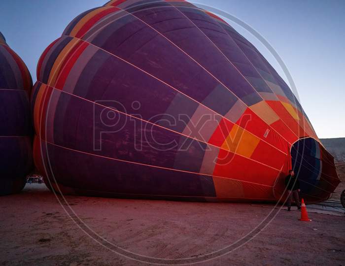 Cappadocia, Turkey - September 14, 2021: Air Hot Air Balloon Being Filled With Helium Gas During Night By A Man, Preparation Of A Flight In Goreme National Park