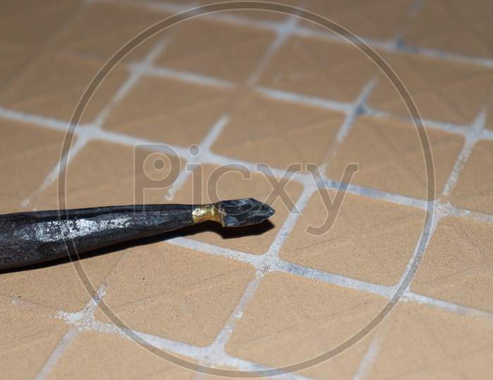 Tile And Glass Cutter On Brown Tile
