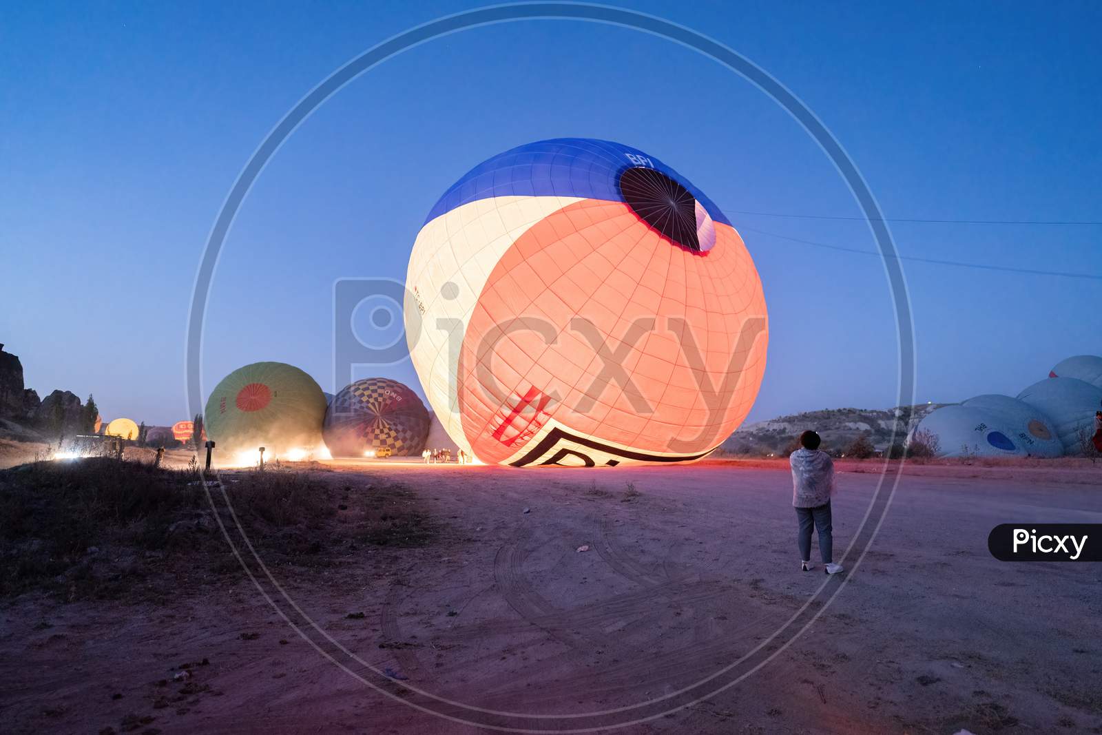 Cappadocia, Turkey - September 14, 2021: Air Hot Air Balloons Being Filled With Helium Gas During Night, Preparation Of A Flight In Goreme National Park In Cappadocia, Turkey