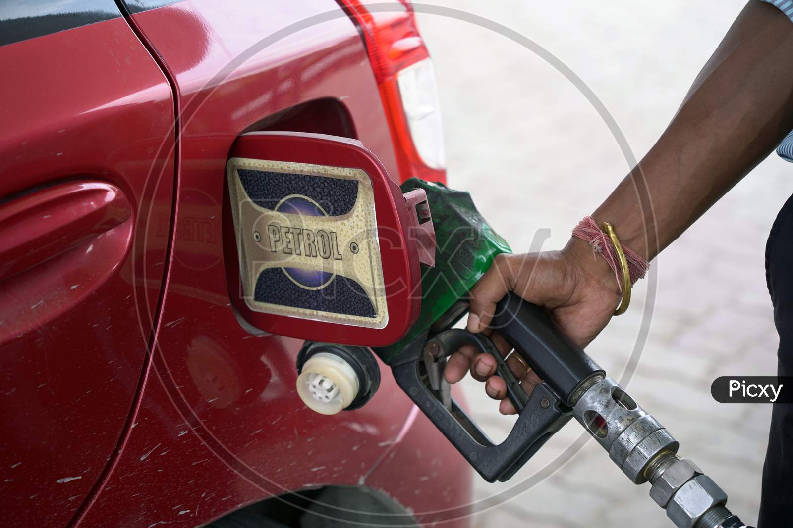 Filling Up Of Car Tank With Petrol At Petrol Pump By Hand Of A Gas Station Attendant