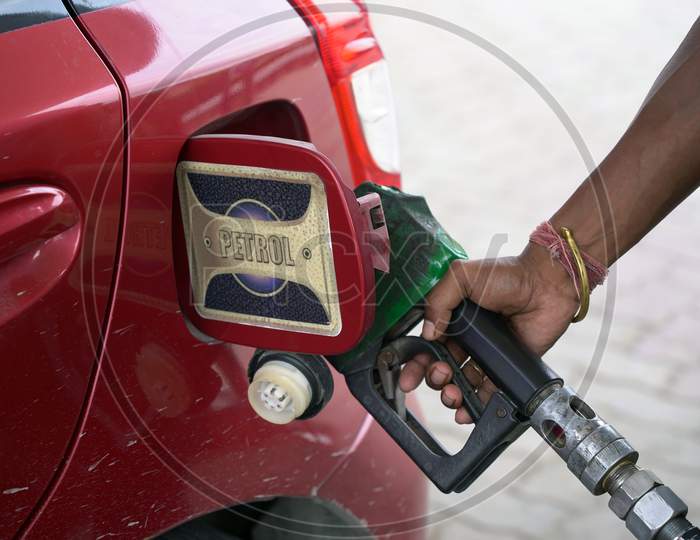 Filling Up Of Car Tank With Petrol At Petrol Pump By Hand Of A Gas Station Attendant