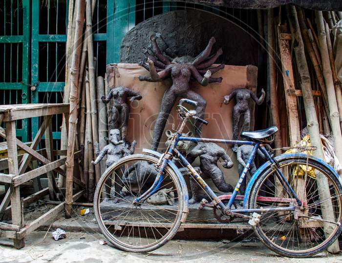 unfinished durga idol and bicycle at kolkata kumortuli