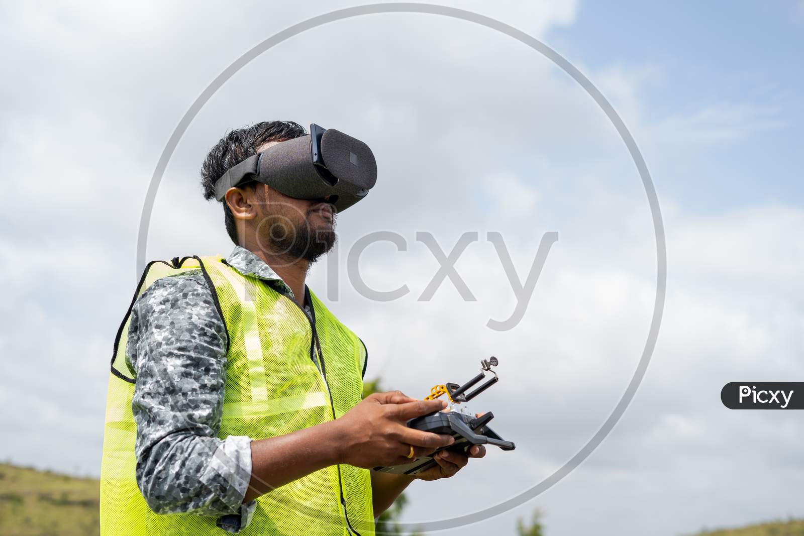 Professional Drone Pilot Controlling Drone By Looking Into Virtual Reality Headset Using Remote Controller - Concept Of Modern Surveillance Technology And Inspection
