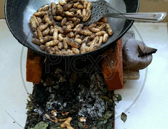 Roasting Peanuts in a Pan on Desi Choolha