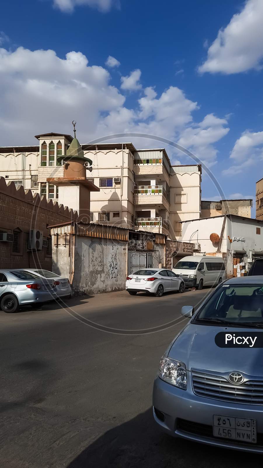 Beautiful buildings and cloudy blue sky and cars on road old city,April,27,2021.