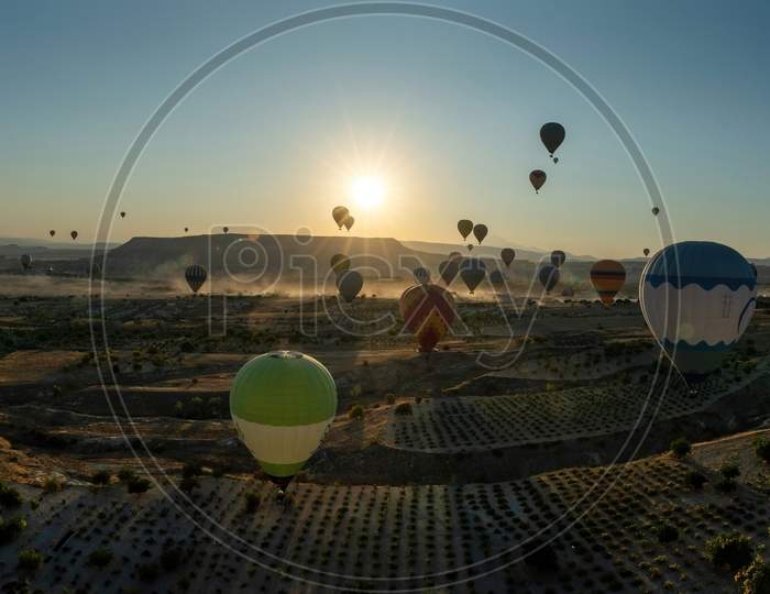 Panoramic View Of Hot Air Balloons Flying Tour Over Mountains Landscape Autumn Sunrise Cappadocia, Goreme National Park, Turkey Nature Background