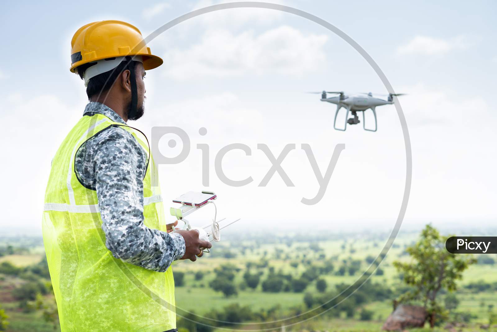 Pilot With Safety Hardhat Flying Drone Using Remote Controller - Concept Of Engineer Doing Aerial Survey Or Inspection Using Uav.