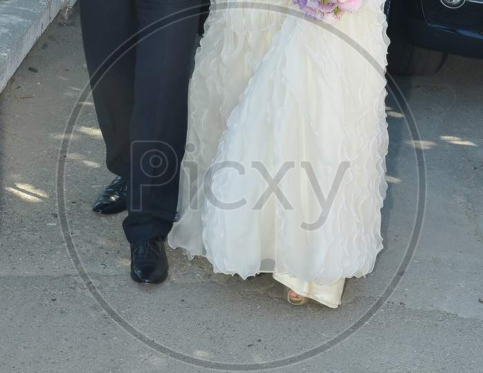 Bride And Groom Walking On The Street