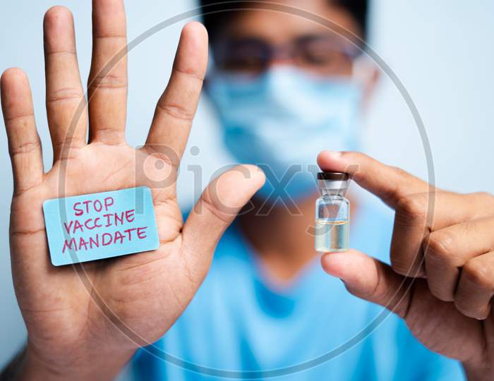 Focus On Hands, Young Man With Medical Face Mask Showing Stop Vaccine Mandate - Concept Vaccine Hesitancy.