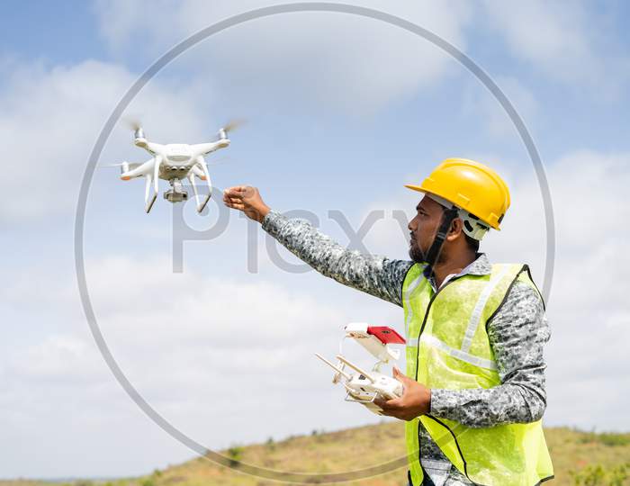 Drone Pilot Safely Receiving Drone Using Remote Controller - Concept Of Return To Home, Aerial Survey Using Uav Technology