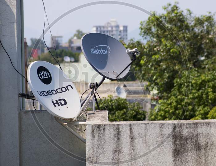 Two Dish Antennas For Receiving Television Broadcasts Signals Installed Of The Top Of A Building